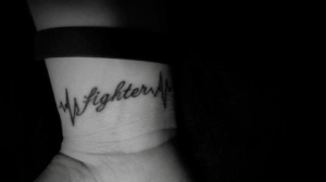 Fighter tattoo on wrist